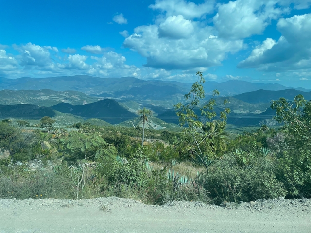 Scenic view of mountains and valleys under a blue sky.
