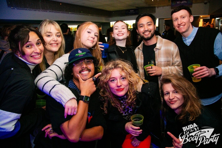 Group of people posing together at a club or party.