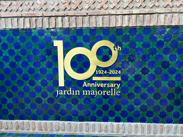 Blue tiled wall with '100th Anniversary 1924-2024 jardin majorelle' text.