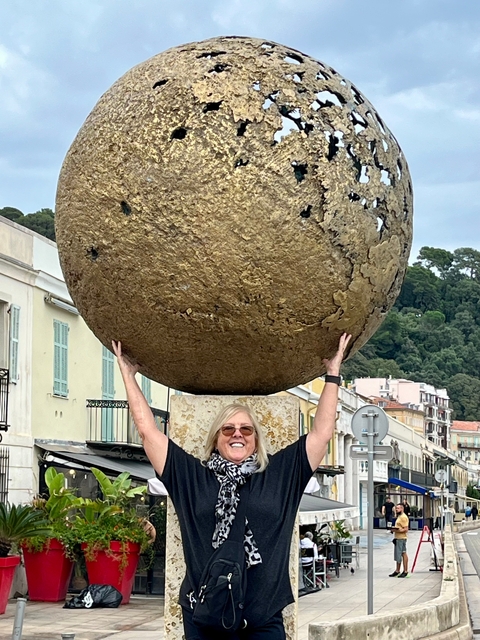 Woman holding a large golden sphere