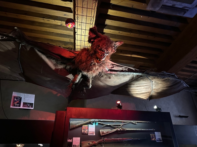 Large, menacing bat sculpture indoors