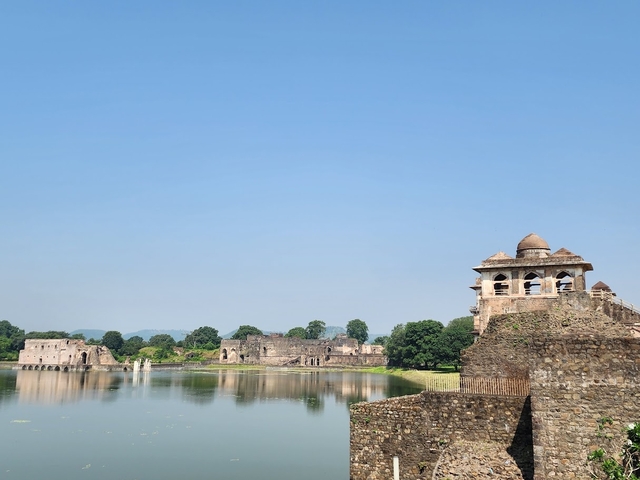 Historic landmarks around a serene lake under a clear blue sky.