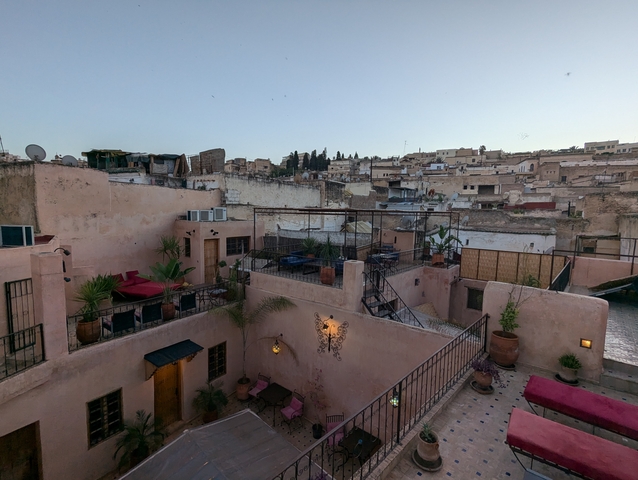 View of a rooftop in a town at dusk.