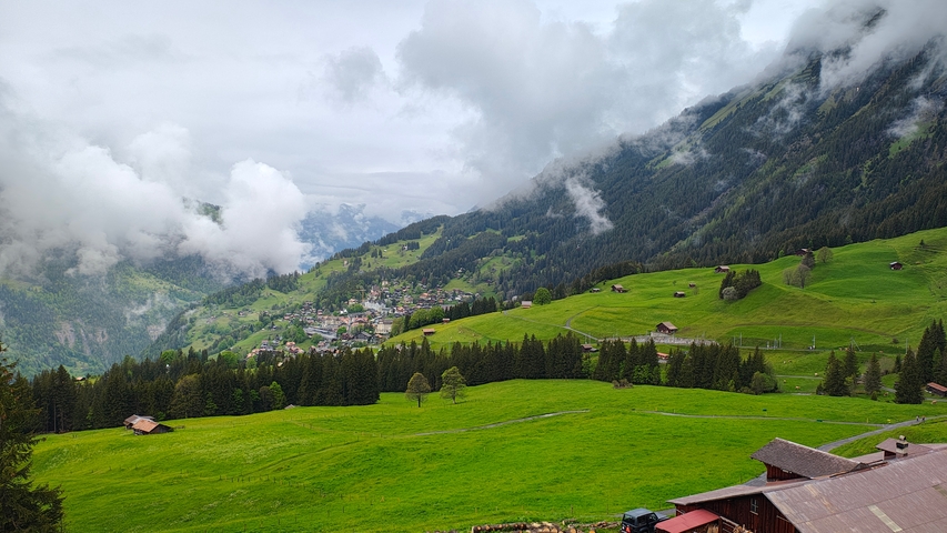 Scenic valley view with green hills and cloudy skies.