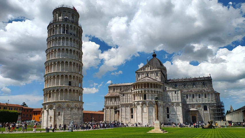       The Leaning Tower of Pisa with cathedral and people.
  