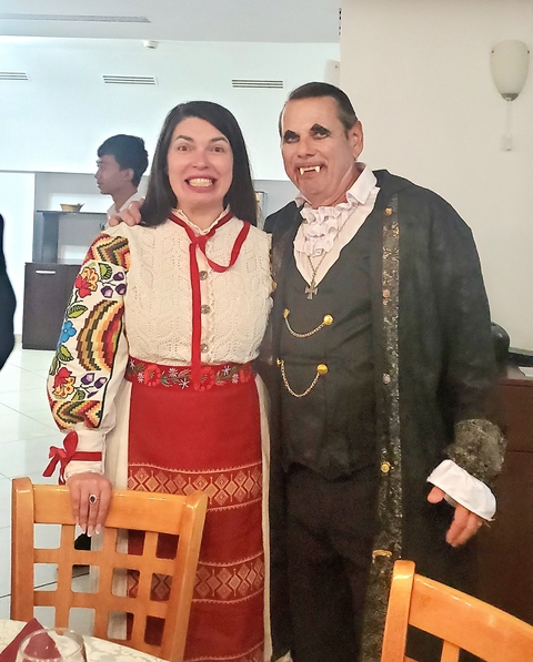 People in traditional costumes posing together.