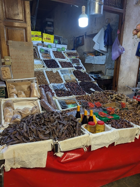      Market stall displaying various dried fruits and spices.
  
