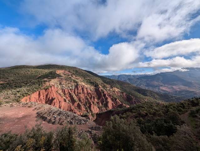       Mountainous landscape with red rock formations.
  