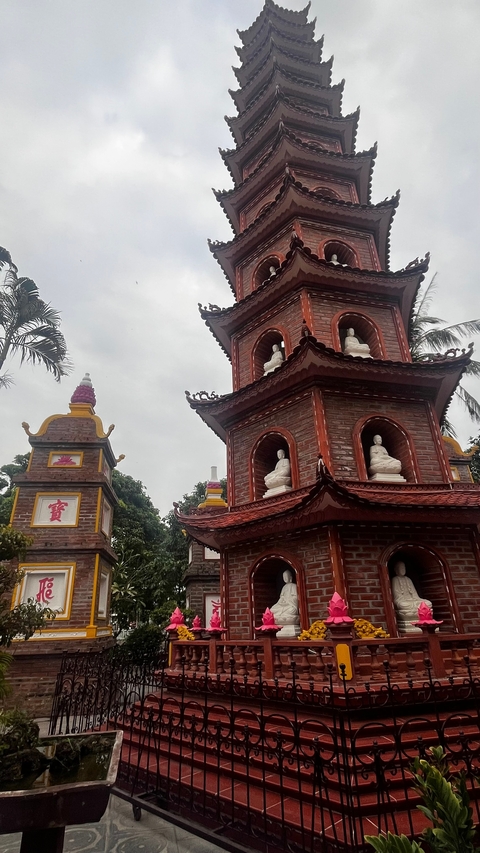 Traditional brick pagoda with Buddha statues.