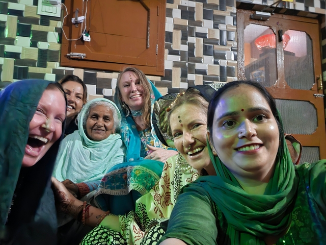 Group of people in traditional attire smiling.