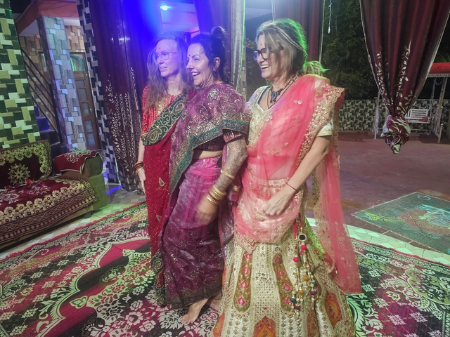 Three women in colorful traditional clothing.