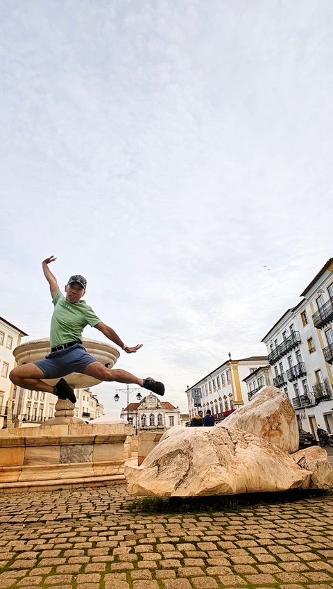Person jumping in a cityscape.