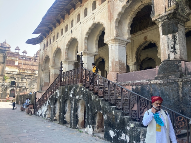       Historic building with multiple arches and stairs.
  