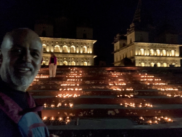       Illuminated steps leading up to historic buildings at night.
  