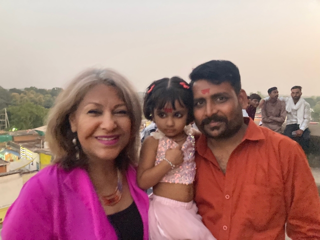       Family posing for a photo outdoors.
  