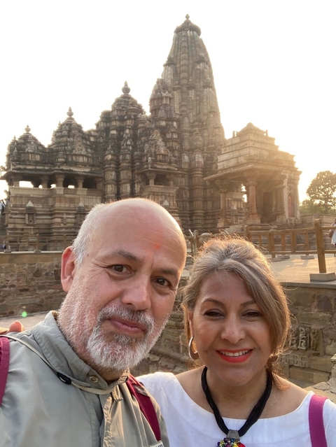       Couple posing in front of a historic temple.
  