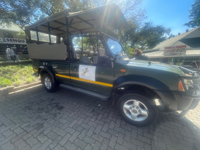 Safari vehicle parked in an outdoor setting.