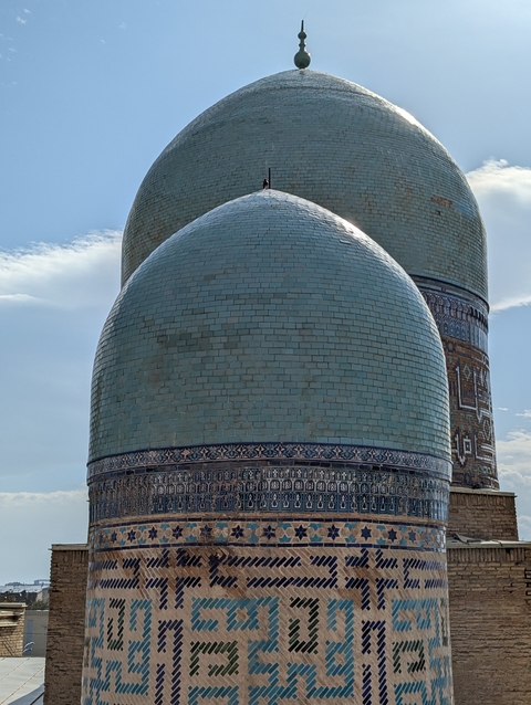 Close-up of two large blue domes of a historic building.