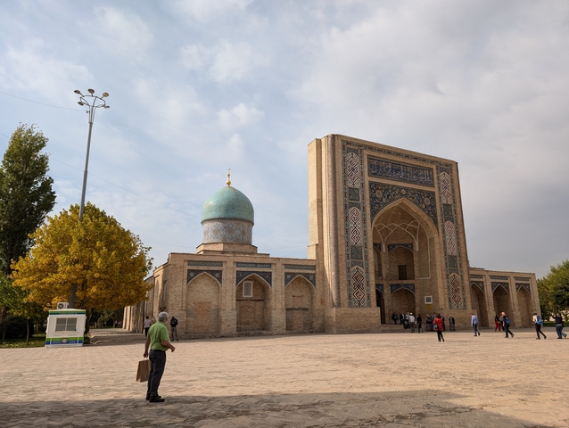 A historical building with a blue dome and decorative facade.
