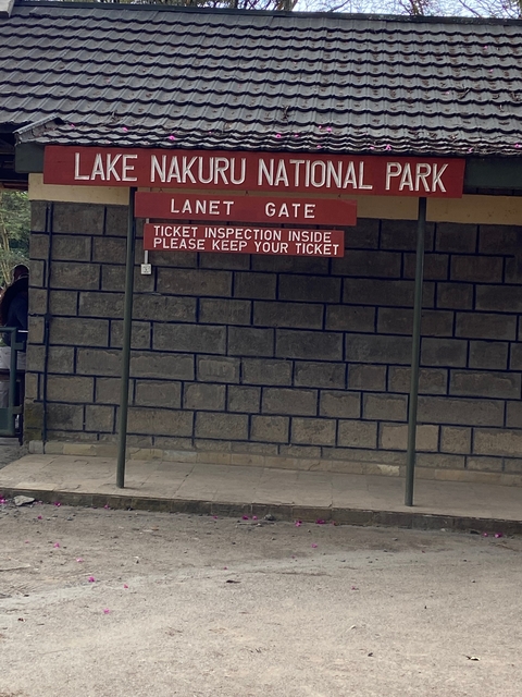       Sign with text about ticket inspection outside a building.
  