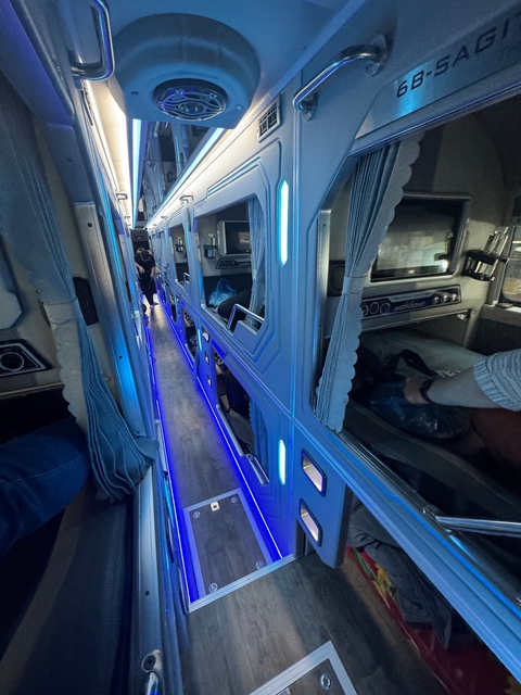 Interior of a sleeper train with blue lighting.