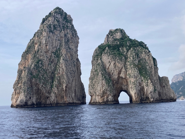       Faraglioni rock formations emerging from the sea.
  
