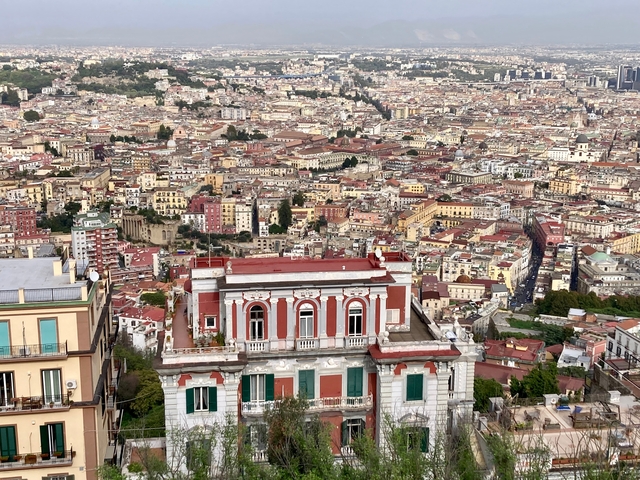       Aerial view of a densely populated city with colorful buildings.
  