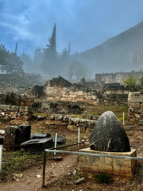 Ancient stone ruins in a misty environment.