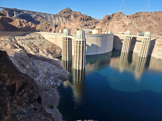       The Hoover Dam with water reflected under a clear sky.
  