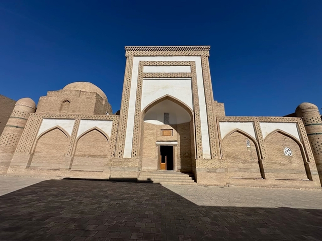       Historic building with distinctive arches and intricate brickwork.
  