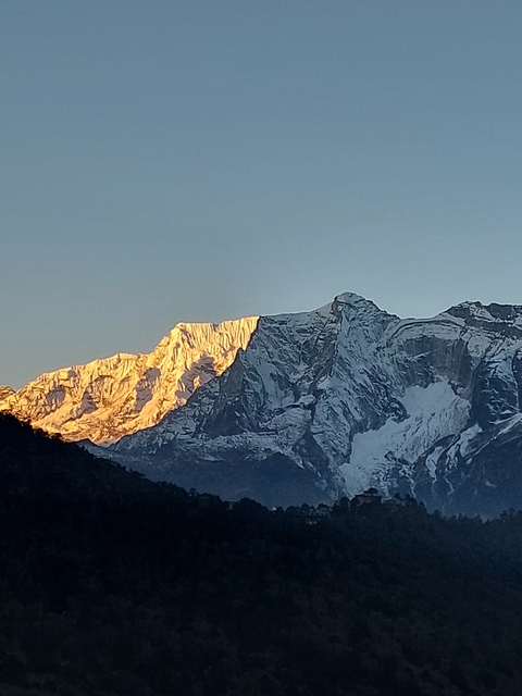       Mountain peaks in golden light.
  