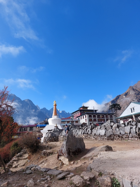       Monastery with mountains in the background.
  