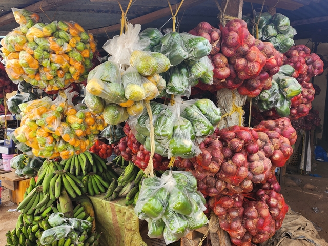 Colorful market stall with produce bags.