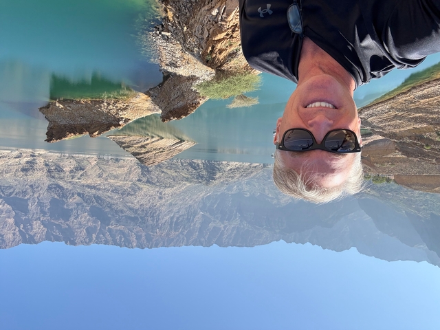 Upside-down image of a man with rocky landscape.
