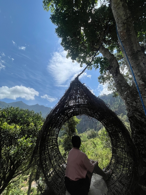 An artistic structure against a mountain backdrop.