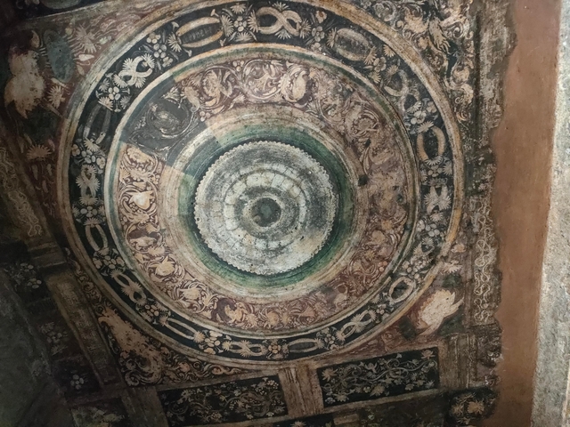 Intricately painted circular ceiling of a cave.