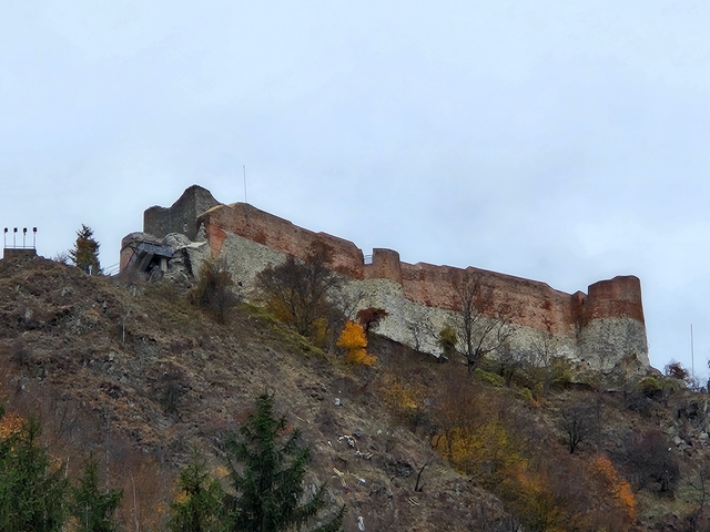      Ruins of a historic fortress on a hill.
  