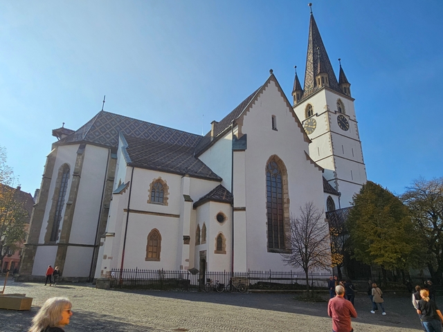       A large church with a clock tower.
  