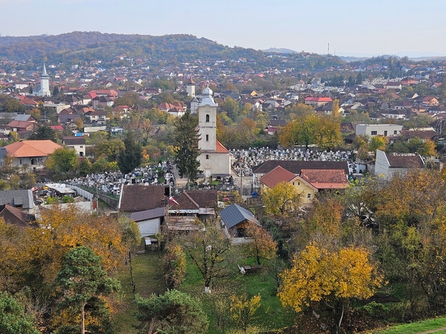 A village with a church and surrounding landscape.