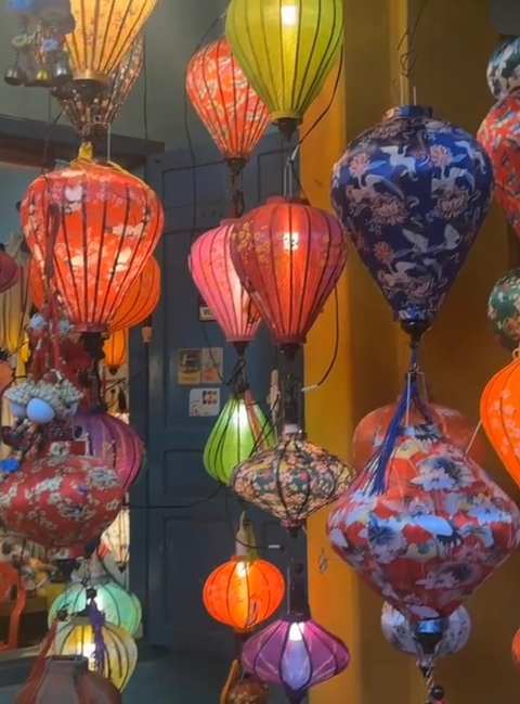 Colorful traditional lanterns displayed at a market or shop.