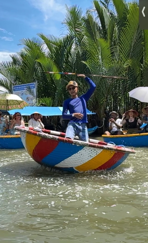 Group of people enjoying a boat ride with a performer in the foreground.