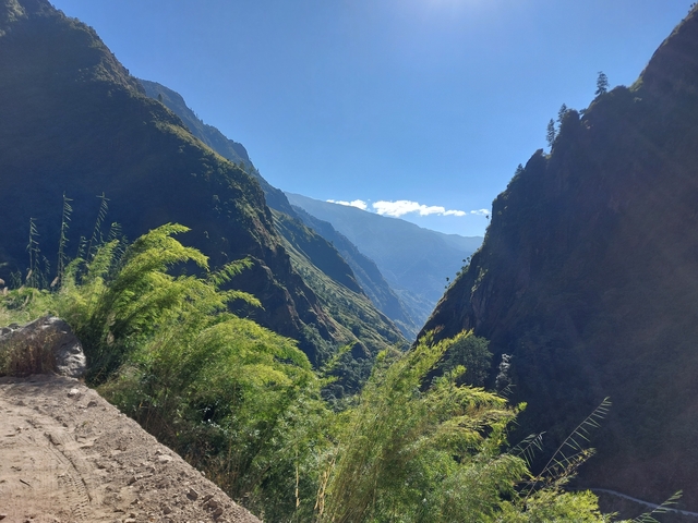 Scenic mountain valley with lush vegetation.