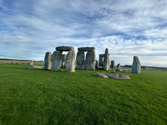       Stonehenge monument under a partly cloudy sky.
  