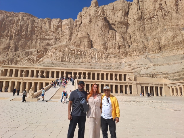 Tourists posing in front of the Temple of Hatshepsut.