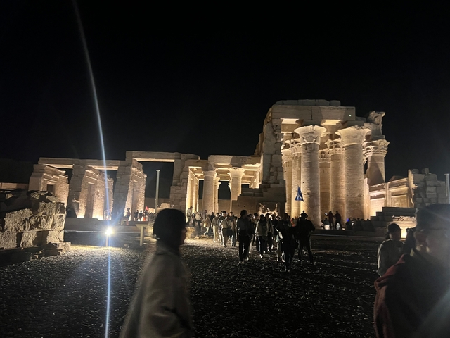       Night view of an illuminated ancient Egyptian temple.
  