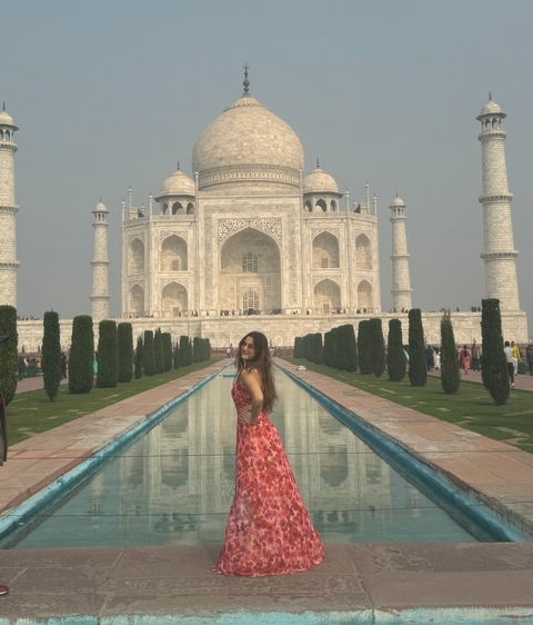 Person standing in front of the Taj Mahal.
