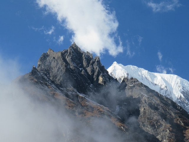 Majestic mountain peaks partially covered by clouds.