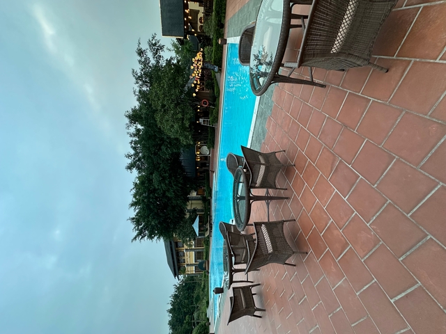 Poolside view with chairs at a resort.