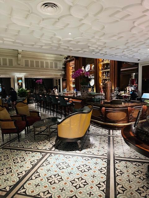 Bar with elegant seating and people inside.