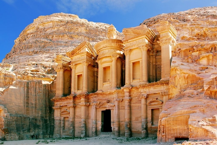       The iconic Al-Khazneh facade carved into a sandstone cliff.
  